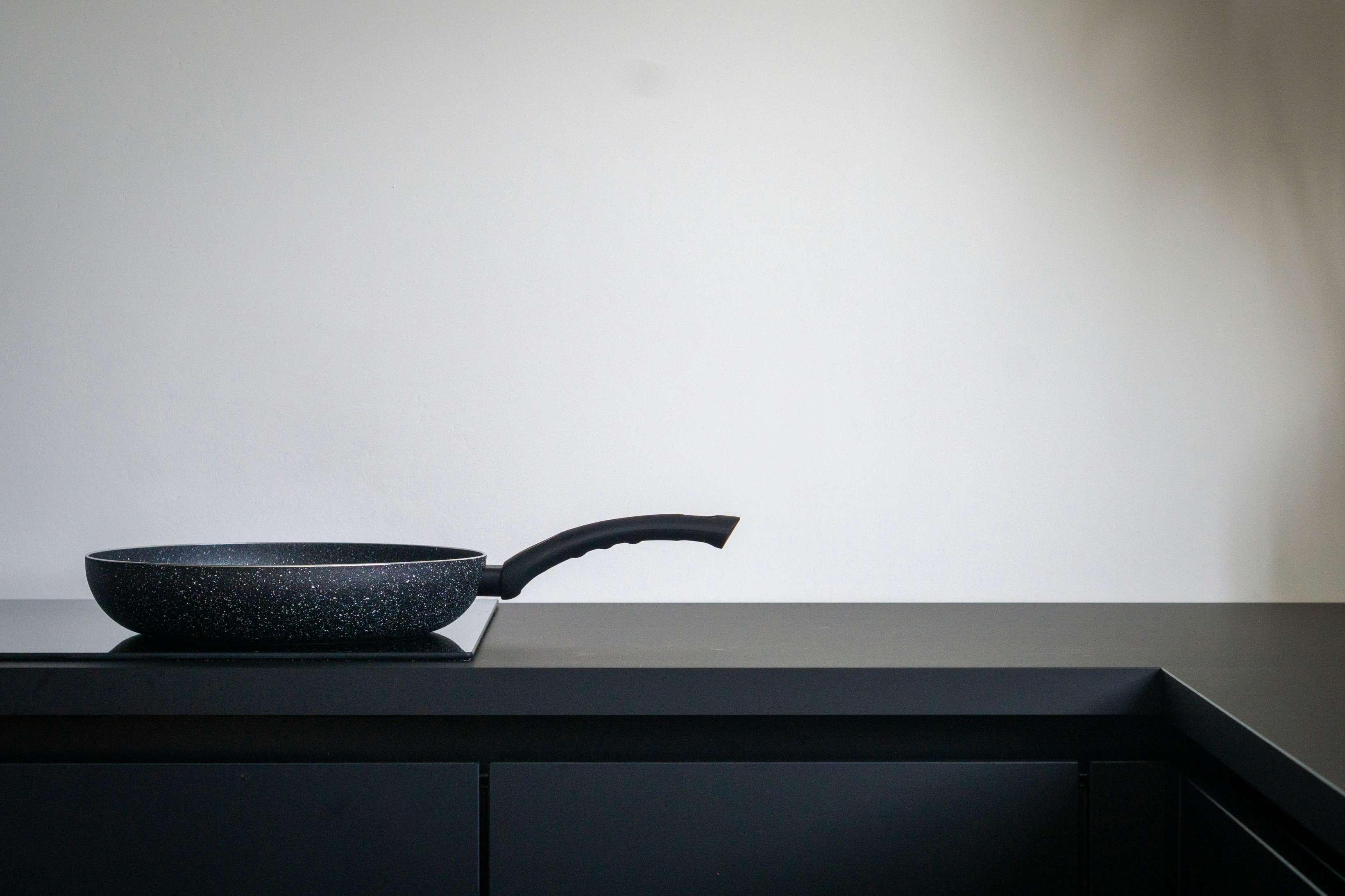 A nonstick frying pan is pictured on a countertop.