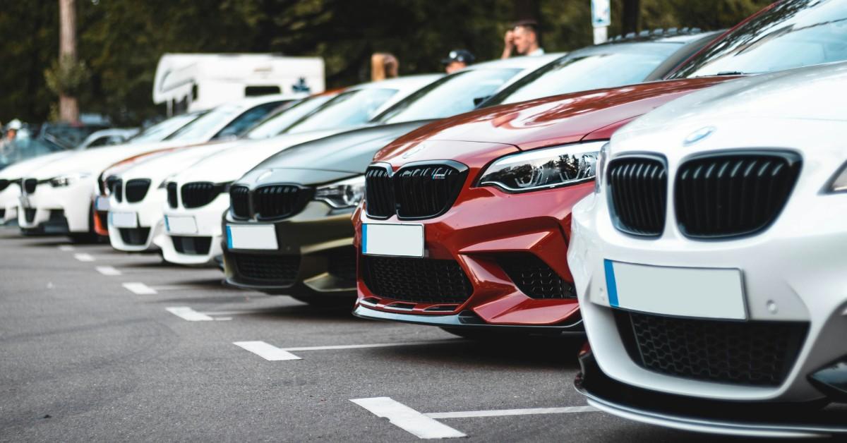A row of cars sits on a lot