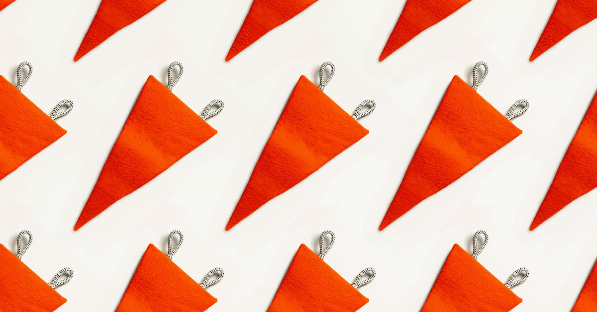 A series of red flags lay against a white backdrop